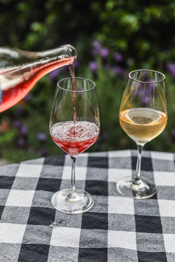 pouring wine on checked table